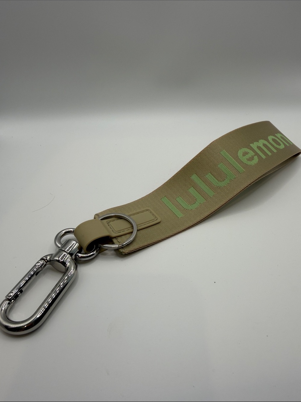 lululemon athletica Tan “Never Lost”Keychain (Woodstock edition) has Lime Logo